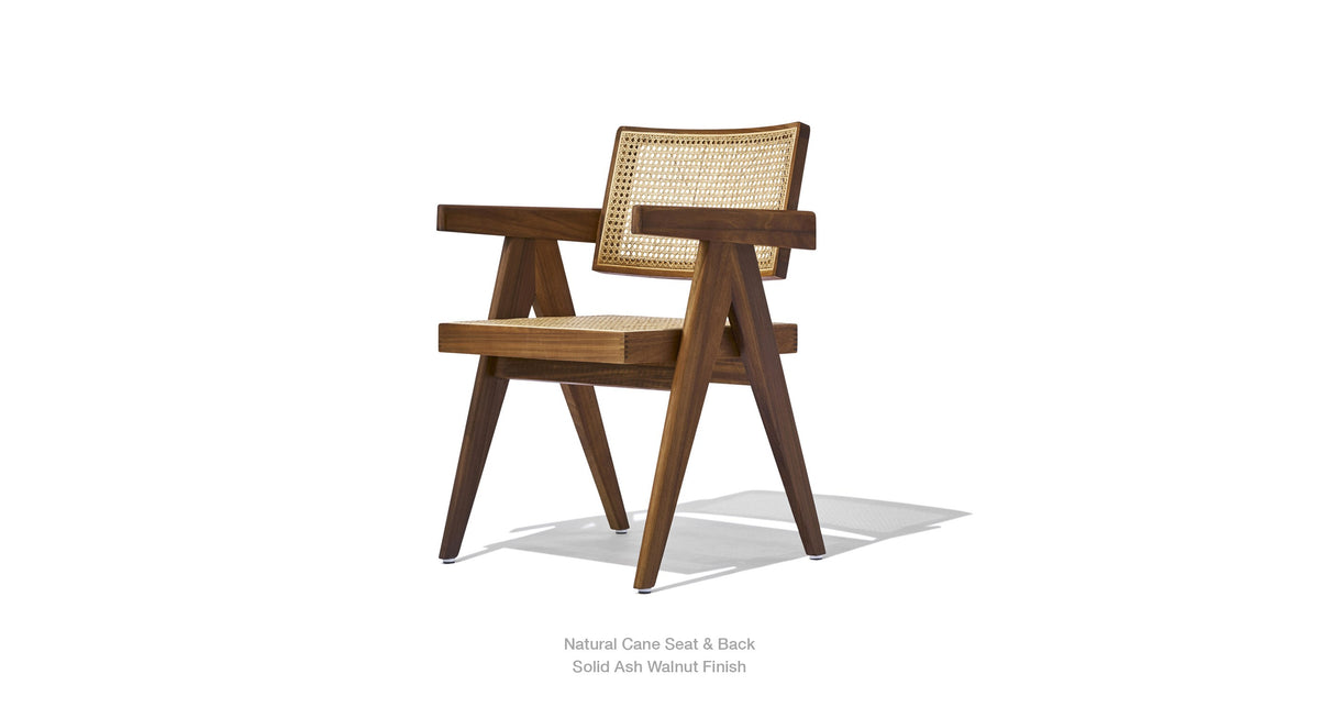 Soho Concept Pierre J Armchair with woven wicker seating and wooden legs, showcasing a stylish and comfortable seating option.