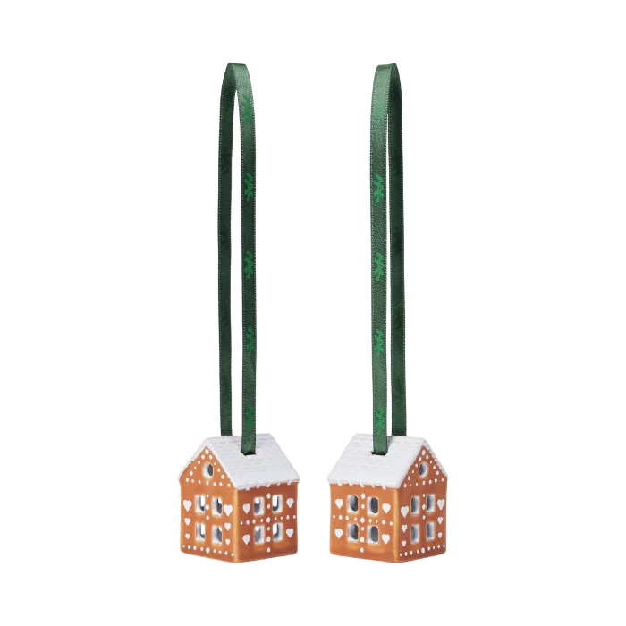 Two Kähler gingerbread ornament accessories, 2 inches tall, featuring detailed gingerbread cookie designs on a festive decorative background.
