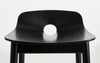 Black Mono Counter Chair by Woud Denmark, modern seating with sleek design and metal legs, ideal for kitchens or bars.