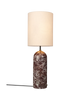 Gubi Gravity XL floor lamp with maroon marble base and sleek lighting design in a modern living space.