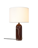 Maroon marble Gubi Gravity Table Lamp with a sleek white lighting fixture, modern design, and elegant aesthetic.