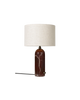 Small maroon marble Gravity Table Lamp by Gubi, featuring a modern lighting design with a sleek base and elegant shade.
