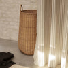 Ferm Living braided laundry basket made of woven natural fibers, stylish accessories for organizing laundry in modern homes.