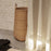 Ferm Living braided laundry basket made of woven natural fibers, stylish accessories for organizing laundry in modern homes.