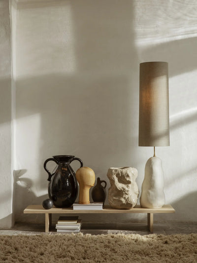 Ferm Living Eclipse lampshade in black with a circular, modern design, hanging from a ceiling light fixture.