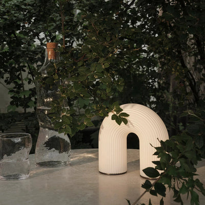 Ferm Living Vuelta Portable Lamp with round white shade and wooden handle, ideal for ambient lighting and easy portability.