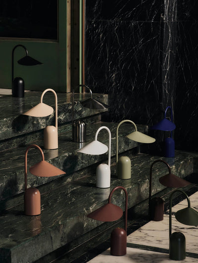 Ferm Living Arum Portable Lamp with sleek modern design, featuring a rounded shape and soft lighting for stylish ambiance.