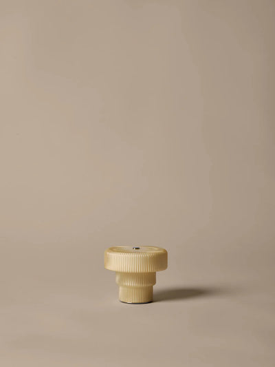 Ripple Portable Lamp by Ferm Living, a stylish modern lighting fixture with a textured ripple design and soft glow.