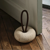 Ferm Living Wa door stopper accessory in neutral color, designed to prevent door movement and protect walls.