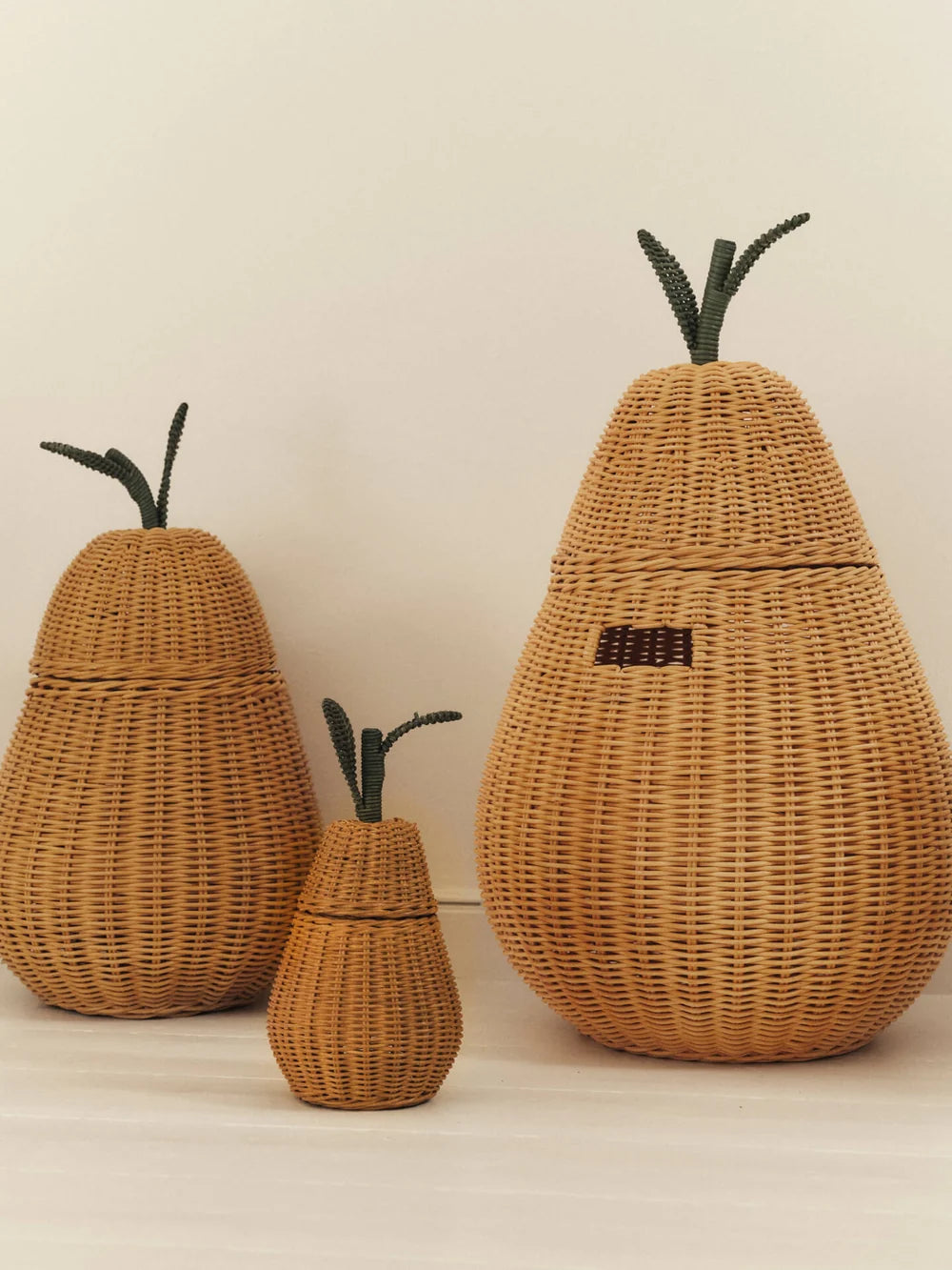 Ferm Living Pear Braided Storage basket for kids, woven with natural fibers, featuring a pear shape and braided design.