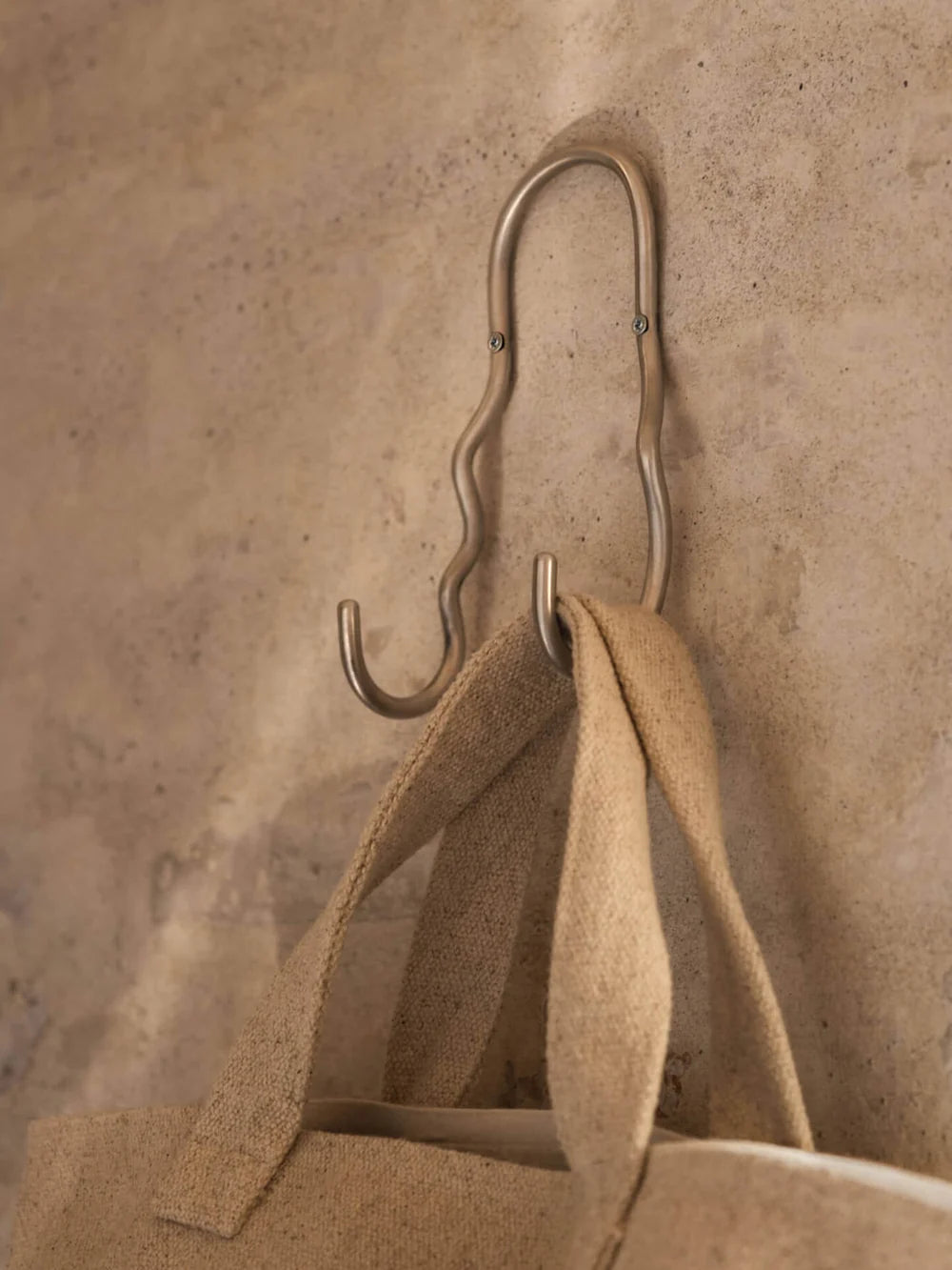 Ferm Living Curvature Double Hook in black metal, wall-mounted accessory with two hooks for hanging coats or accessories.