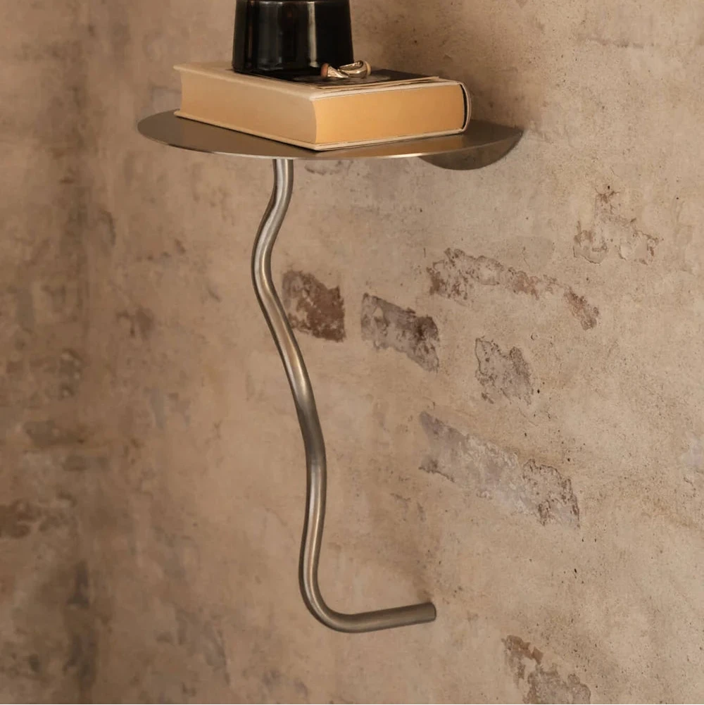 Ferm Living Curvature Wall Table mounted on a wall, featuring a sleek, minimalist design in a modern interior setting