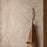 Ferm Living Curvature Hook in black metal, wall-mounted accessory for hanging items, modern minimalist design.