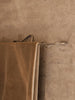 Ferm Living Curvature Towel Hanger in matte black with a sleek, curved design mounted on a bathroom wall for towels.
