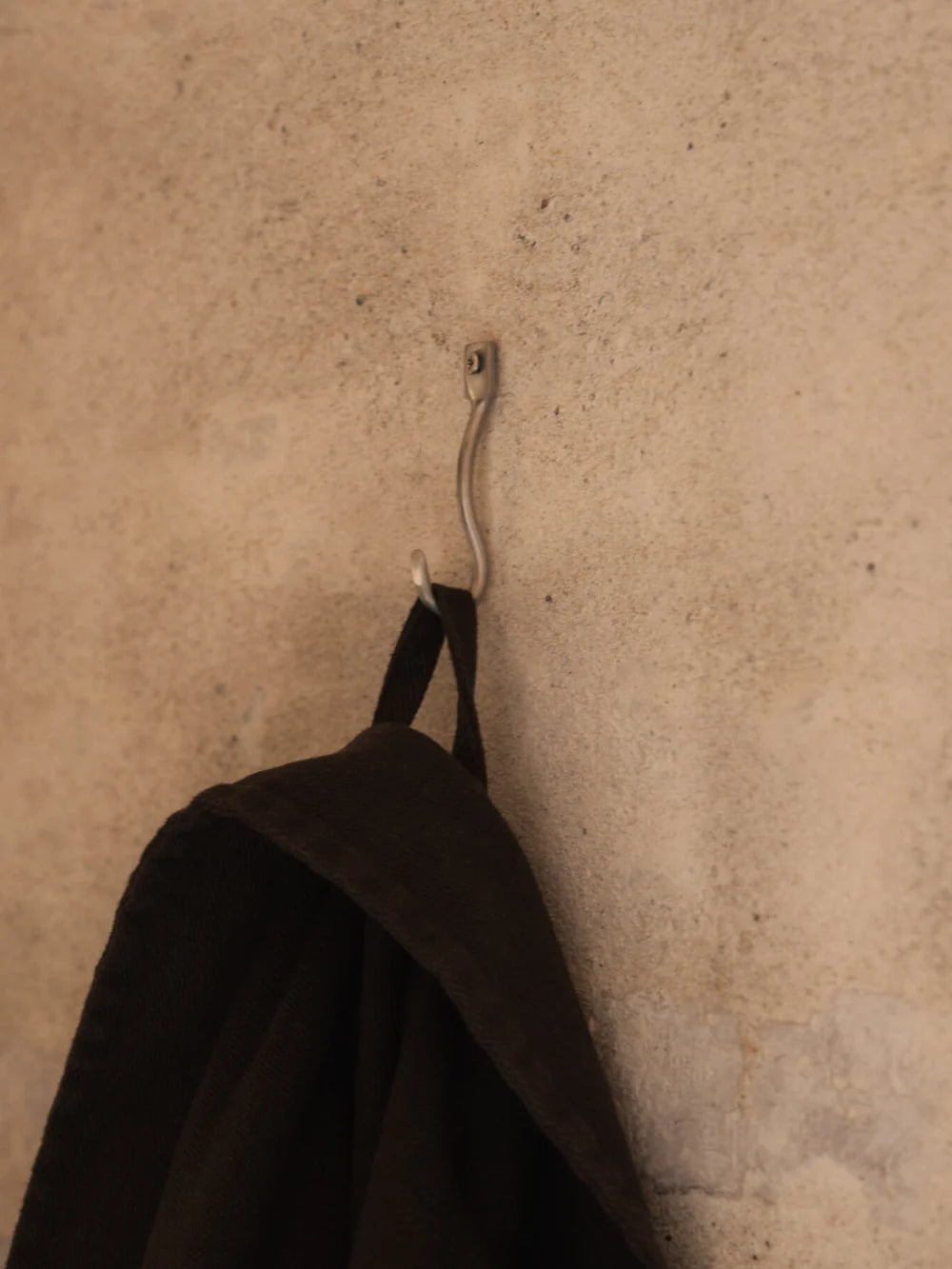 Set of three Ferm Living Curvature Hooks, modern wall-mounted accessories with sleek curved design for hanging items.