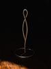 Ferm Living Curvature Paper Towel Holder in black metal with sleek curved design for kitchen countertop use.