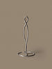 Ferm Living Curvature Paper Towel Holder in black with curved metal design for kitchen or bathroom accessories.