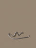 Ferm Living Curvature toilet paper holder in modern black metal, mounted on a bathroom wall for convenient use.