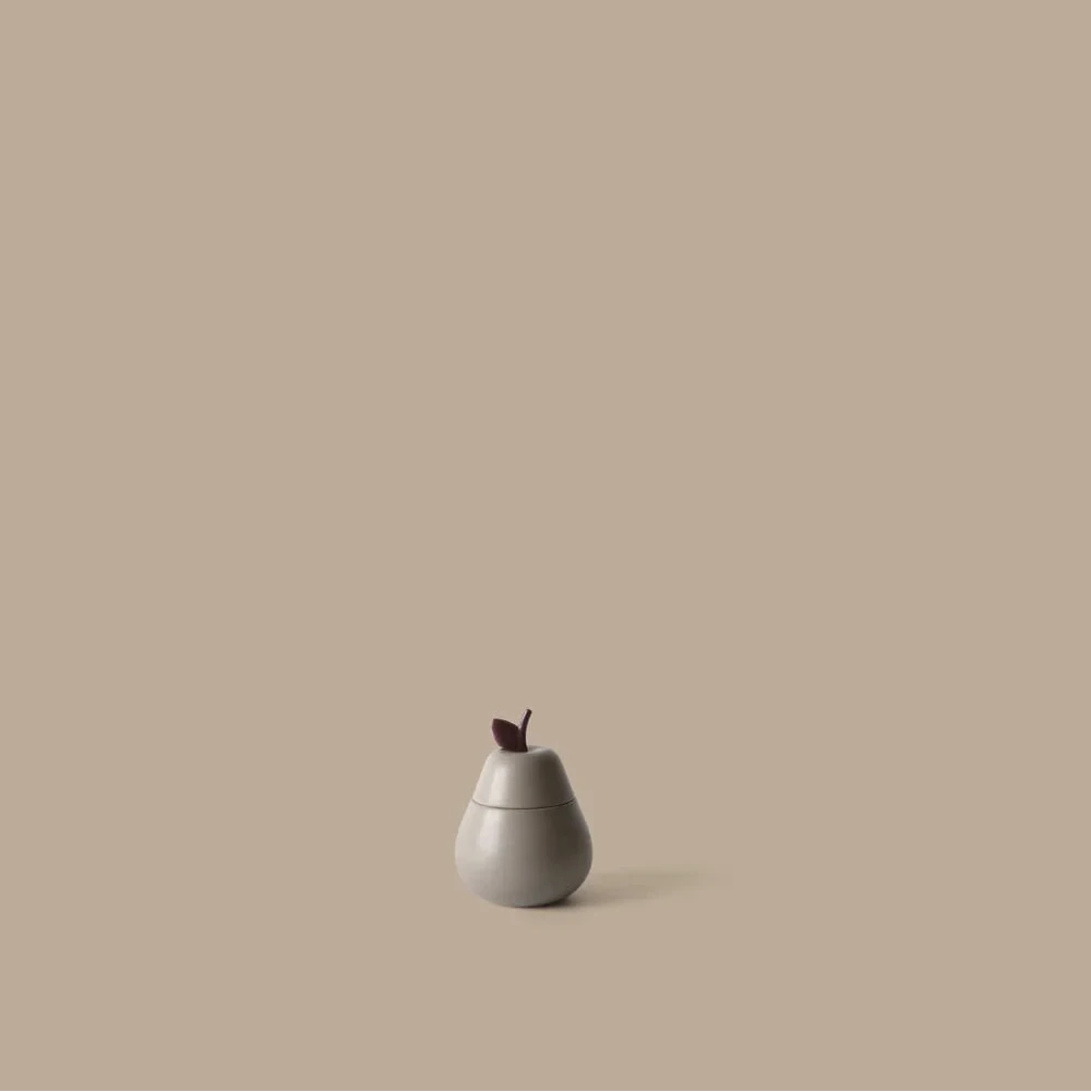 Ferm Living Pear ceramic container for kids, decorative ceramic storage in the shape of a pear with a smooth finish.