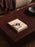 Ferm Living Burl Coffee Table with rounded wooden surface and modern design, ideal for living room decor.