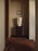 Ferm Living Burl side table with a round wooden top and sleek metal legs, modern Scandinavian design for living room decor.