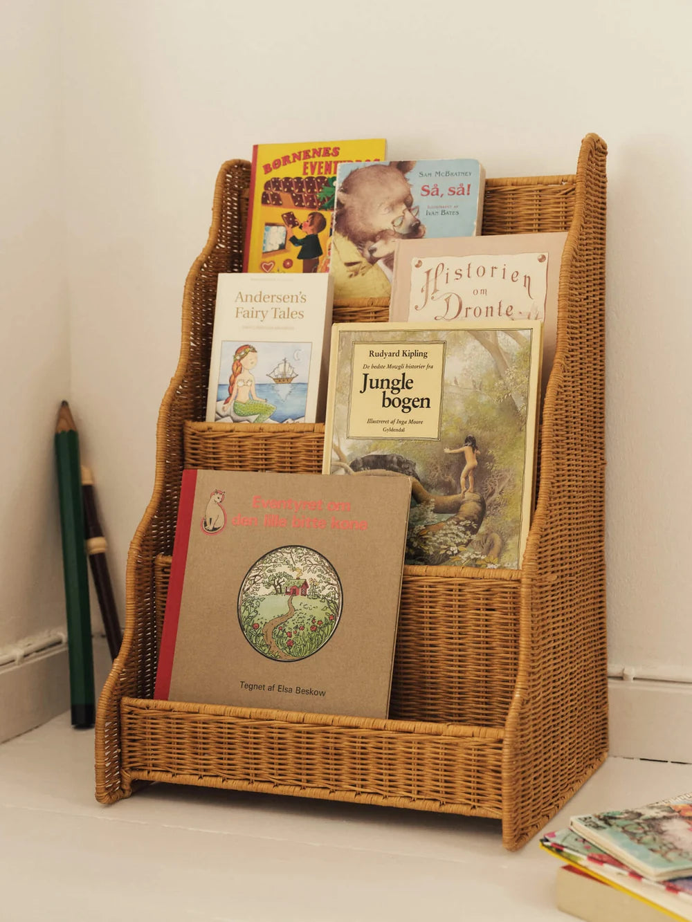 Ferm Living Rivan Kids display bookcase with open shelves in natural wood finish, perfect for children's room organization.