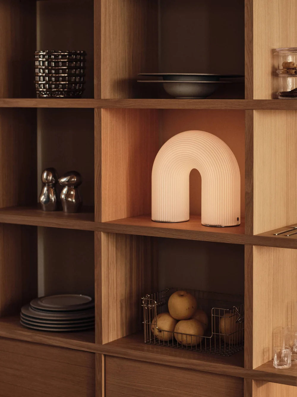 Vuelta outdoor portable lamp by Ferm Living featuring a sleek, modern design with a handle for easy carrying and ambient lighting.