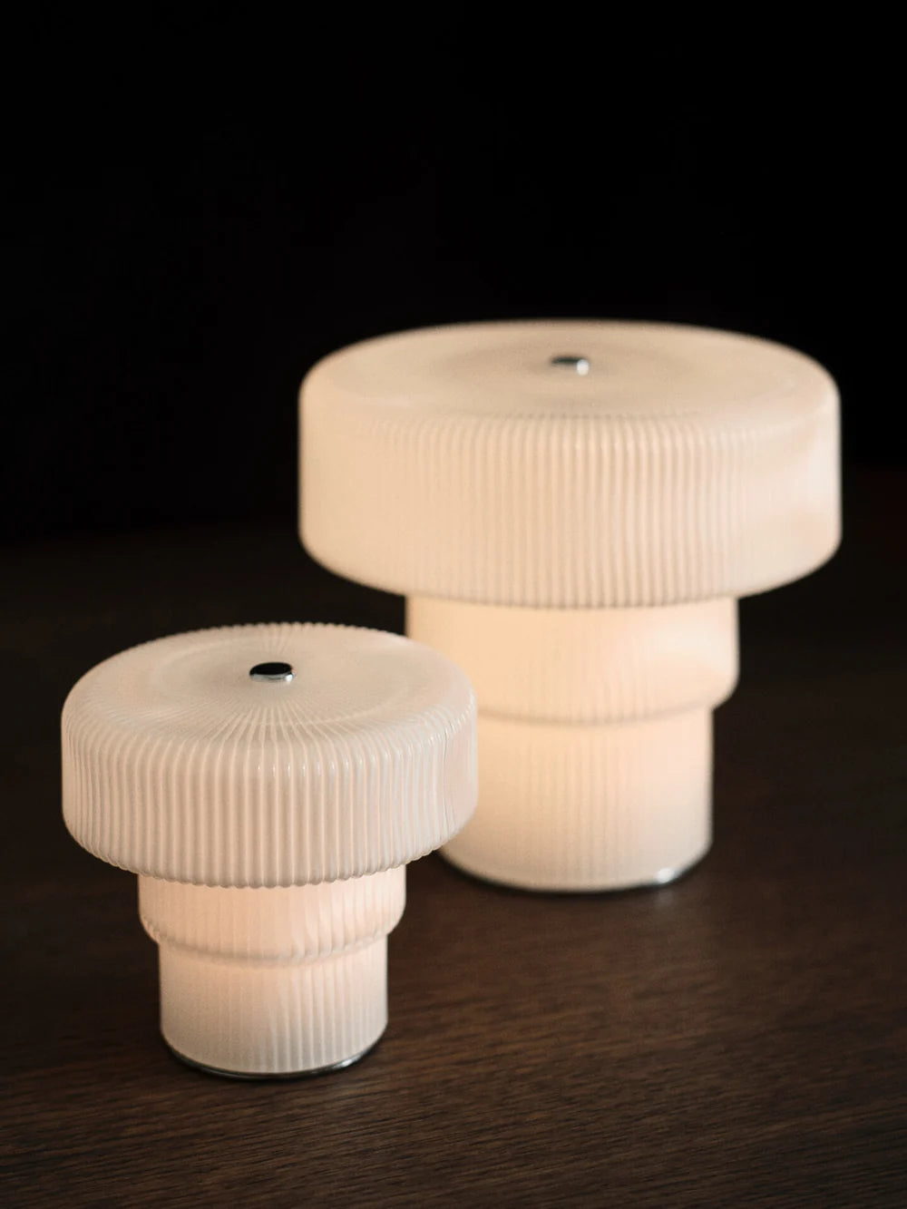Large Ferm Living Ripple Portable Lamp with textured ceramic base and fabric shade, designed for stylish ambient lighting.