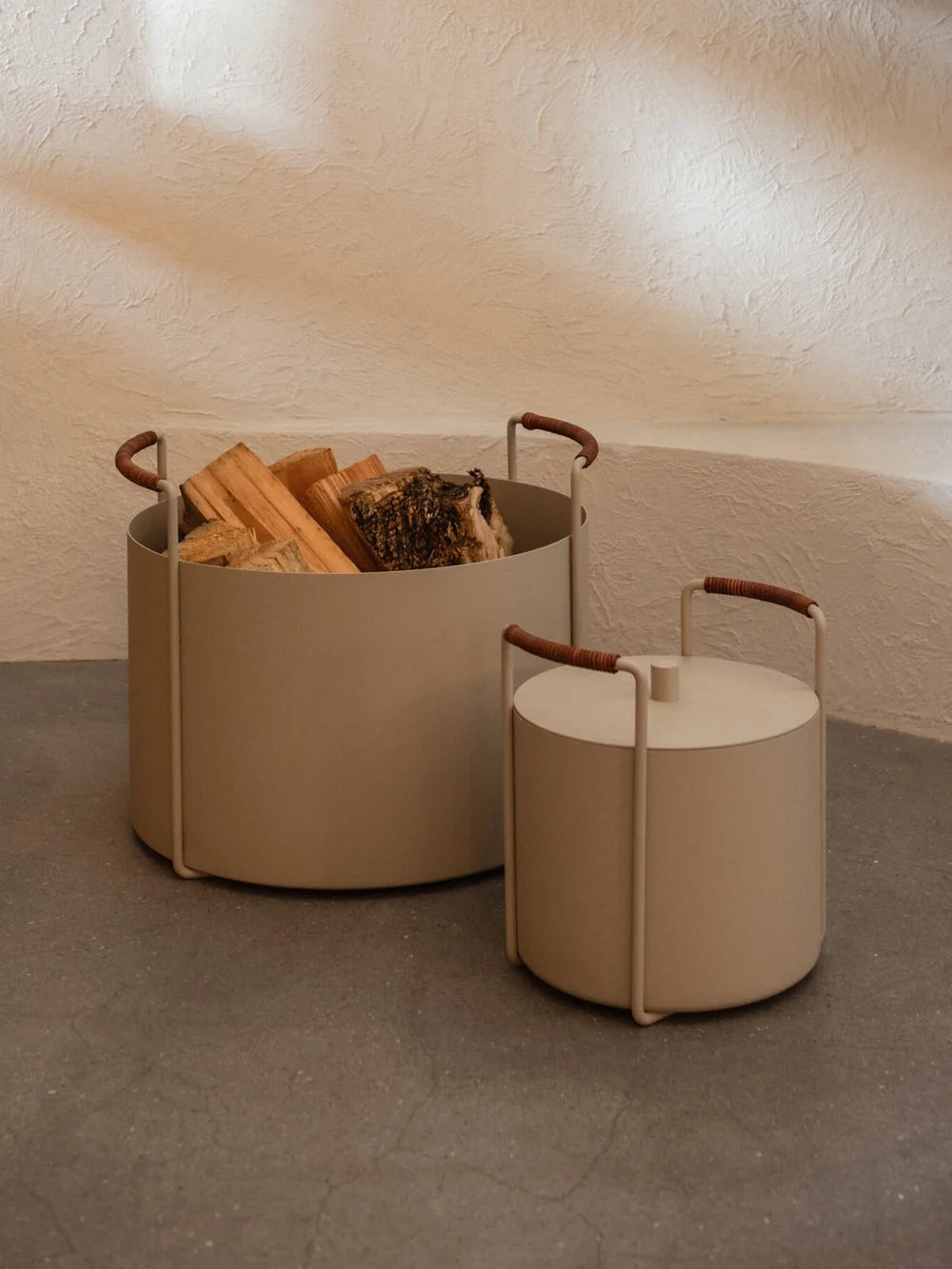 Ferm Living Port Firewood Bucket in black with wooden handle, stylish accessory for storing firewood or kindling in modern homes.