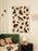 Ferm Living Loopi wall clock for kids, with a colorful circular design and modern style, hanging on a wall.