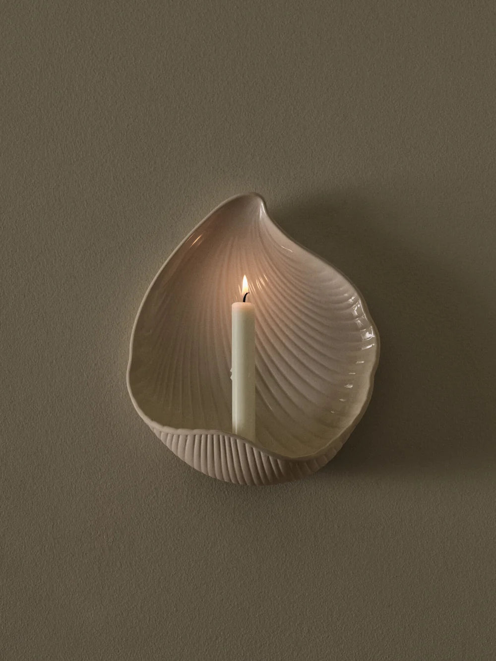 Ferm Living Shell Wall Candle Holder in beige, designed as a decorative wall accessory with a shell-inspired shape.