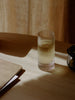 Set of two Ferm Living Ripple Highball Glasses featuring textured, wavy glass design for stylish beverage presentation.