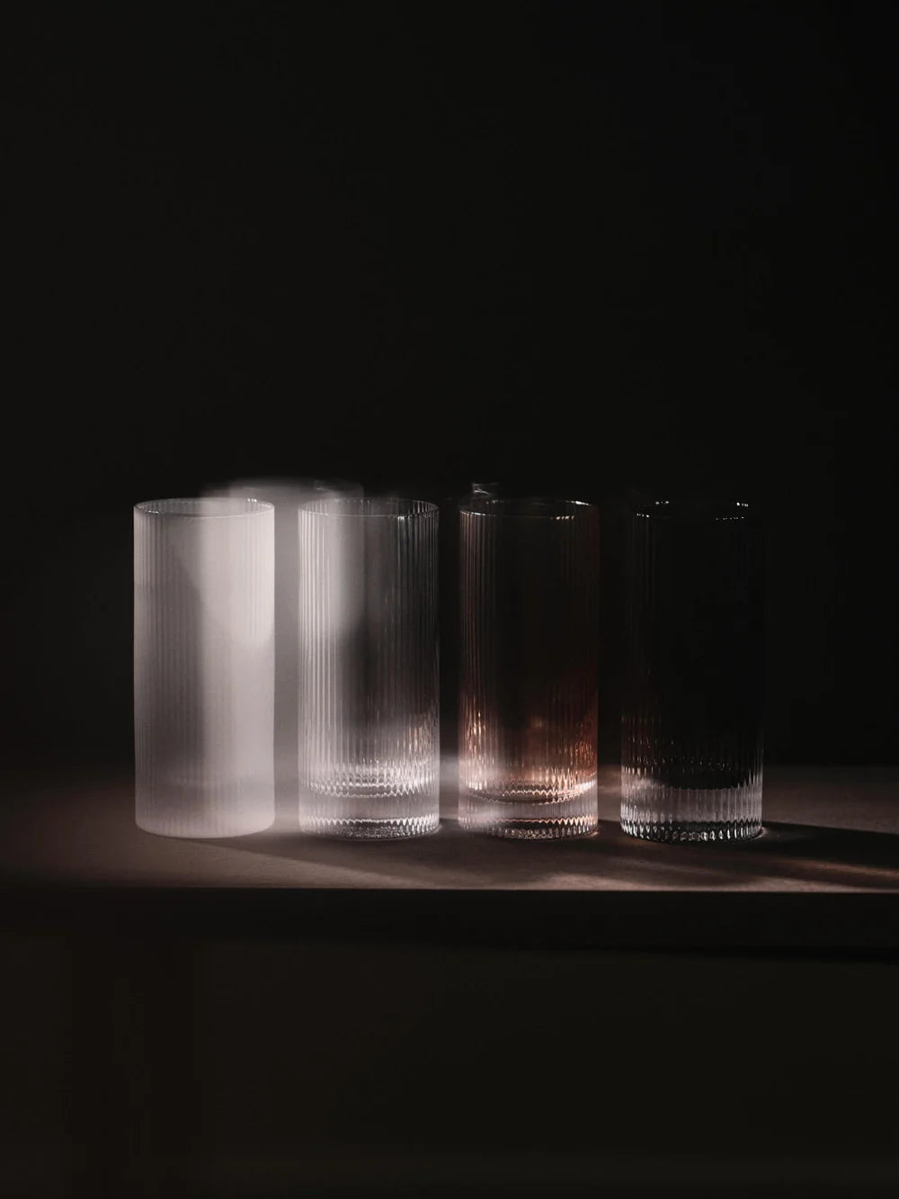 Set of two Ferm Living Ripple Highball Glasses with textured, wavy design perfect for stylish beverages and entertaining.