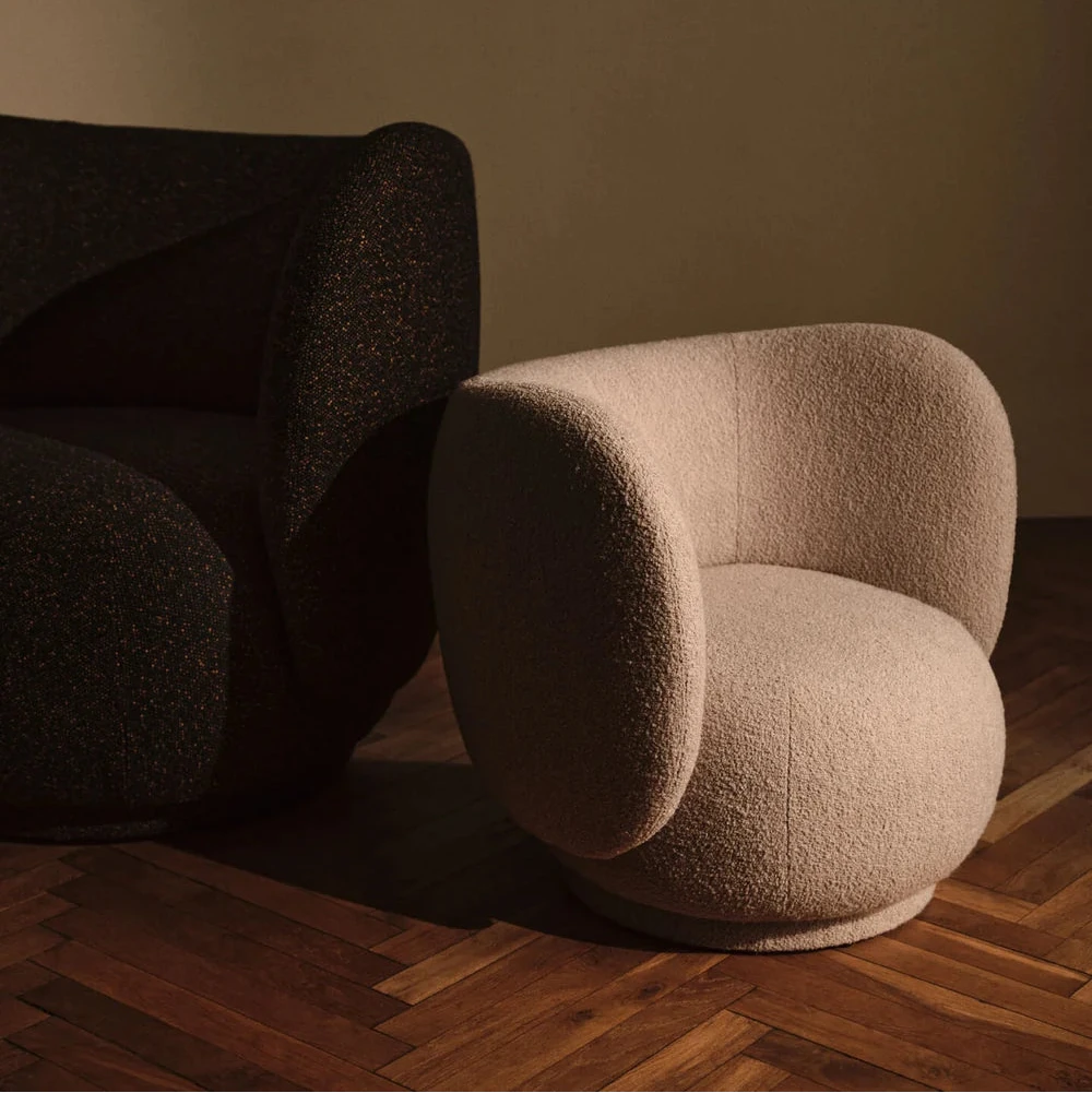 Ferm Living Rico Kids Lounge Chair with soft fabric and wooden legs, perfect for children's cozy reading or relaxing space.