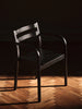 Ferm Living Boda dining chair with armrests, modern seating with wooden legs and upholstered seat, stylish for dining rooms.