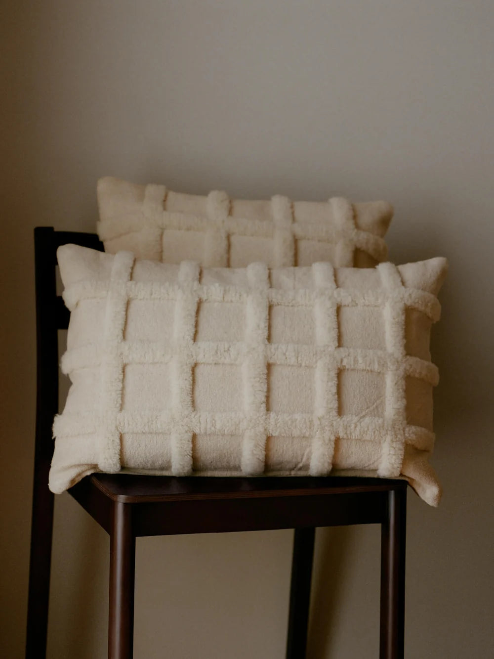 Ferm Living Norte Grid Cushion in neutral fabric with a modern geometric pattern, designed for home accessories and decor.