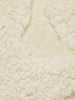 Ferm Living Rime tufted cushion with textured fabric and soft filling, used as a stylish home accessory.