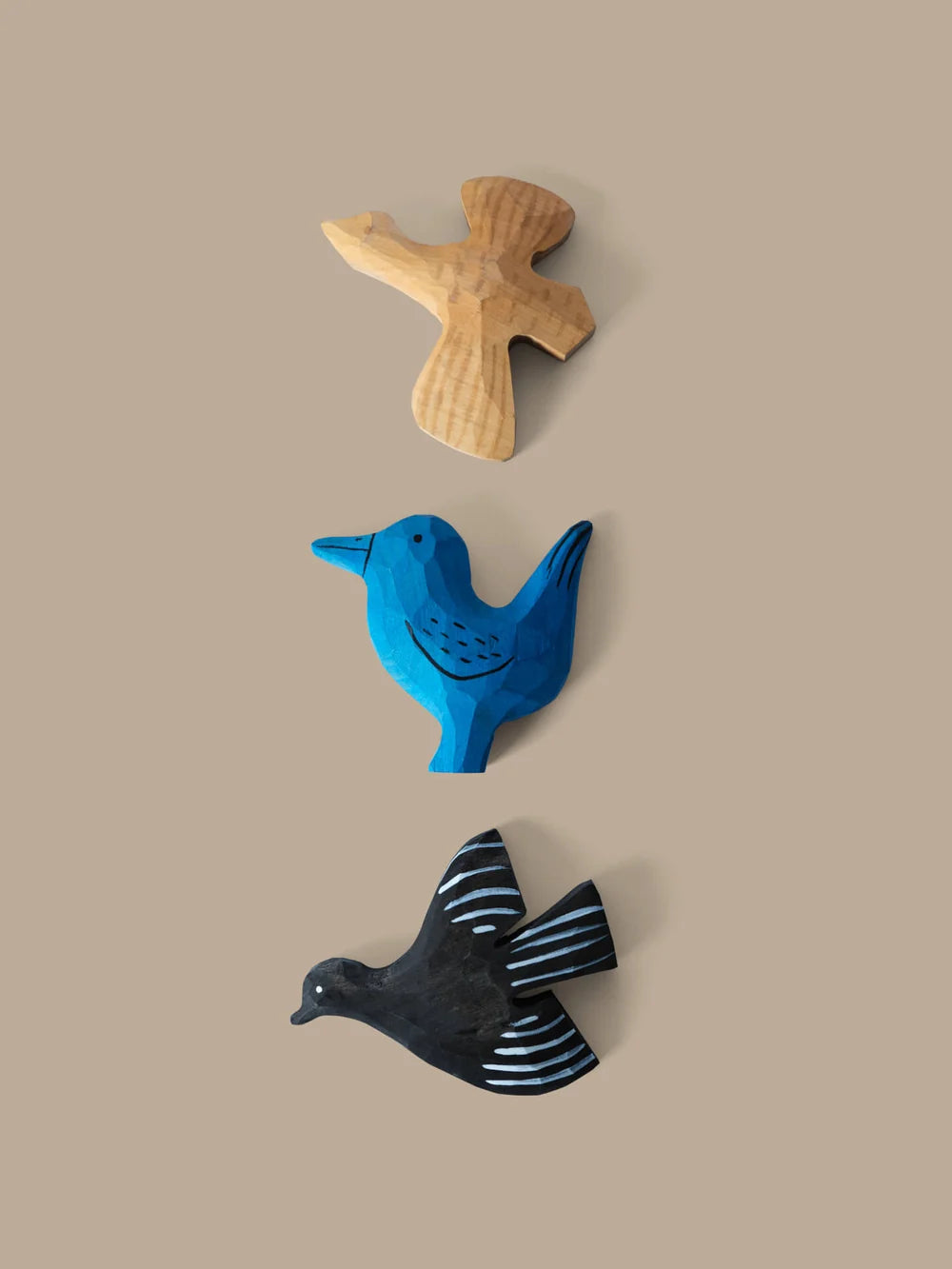 Set of three hand-carved bird magnets for kids by Ferm Living, featuring detailed wooden bird designs for playful decor.