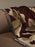 Ferm Living Cilla Tapestry Blanket featuring intricate woven pattern, soft fabric, and decorative fringe edges.