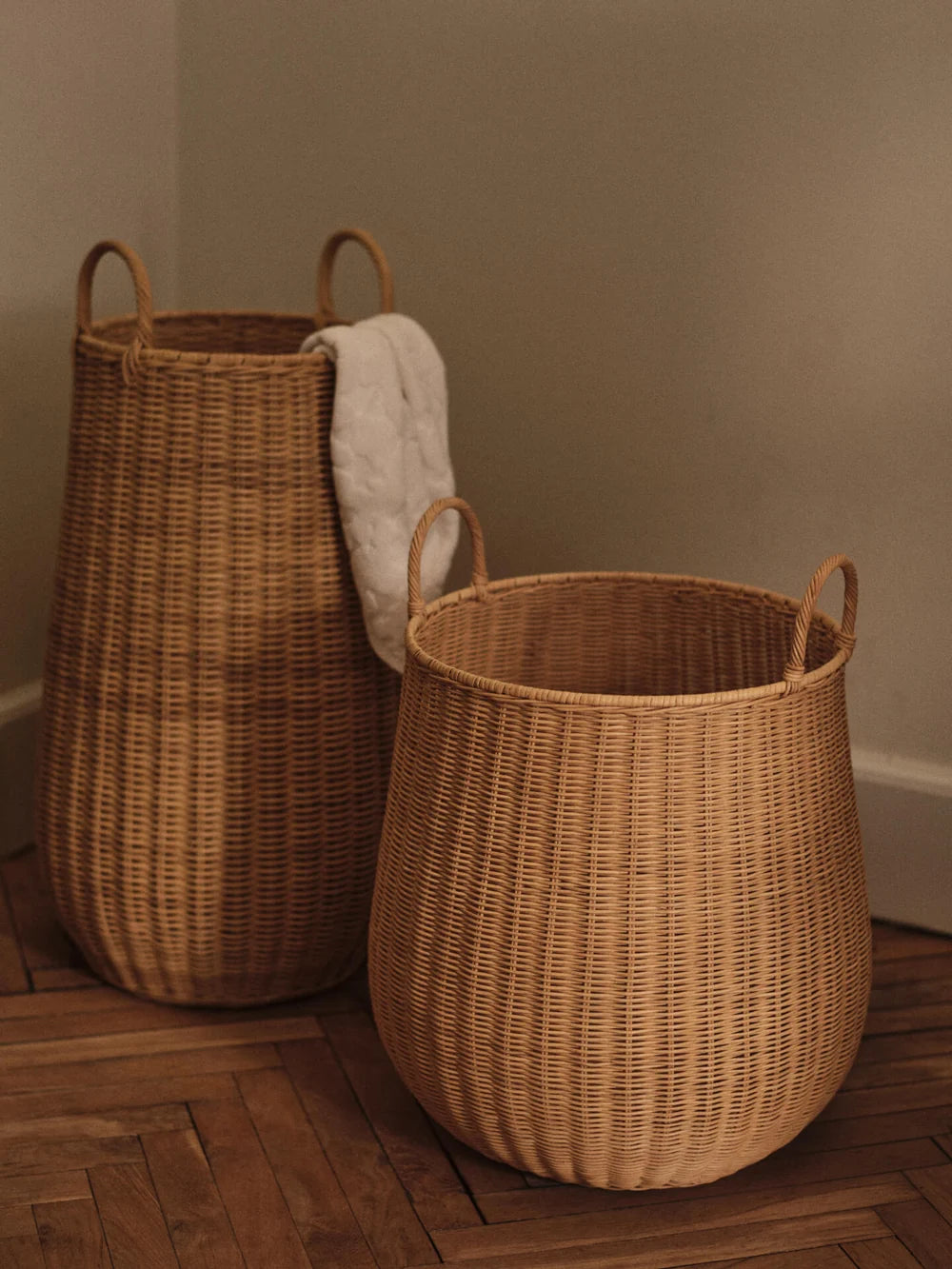 Ferm Living braided laundry basket made of woven natural fibers, designed as a stylish storage accessory for laundry or organization.