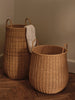 Ferm Living braided laundry basket made of woven natural fibers, designed as a stylish storage accessory for laundry or organization.