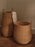 Ferm Living braided laundry basket made of woven natural fibers, designed as a stylish storage accessory for laundry or organization.