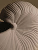 Ferm Living Shell Pot accessory with a sleek, modern design, featuring a shell-shaped pattern in neutral tones.