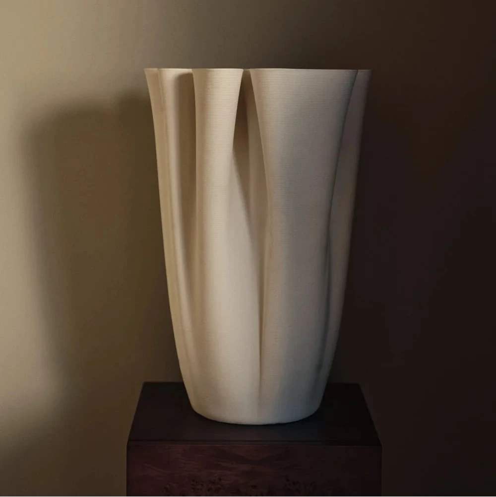 Ferm Living Dedali Floor Vase in textured ceramic with a modern, sculptural design, standing tall on a neutral background.