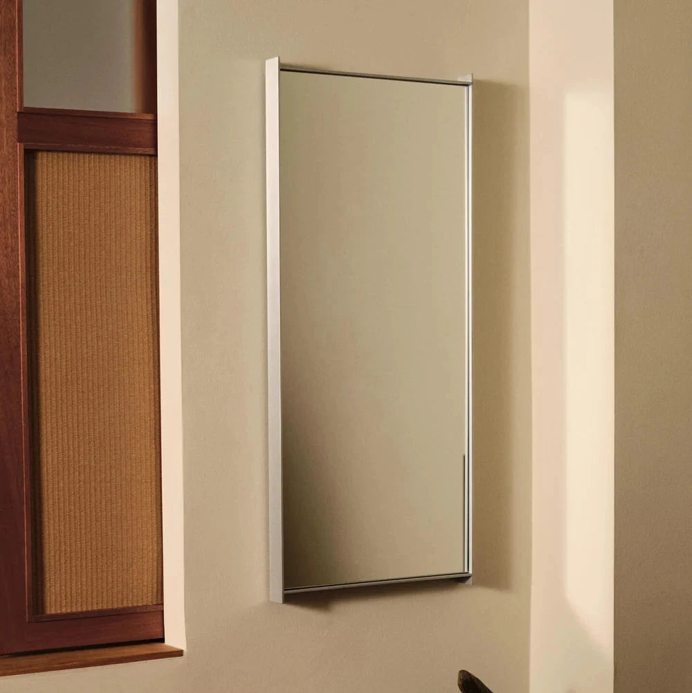 Ferm Living Lager Mirror - Narrow accessory mounted on a wall, featuring a sleek, minimalist design with a black frame.