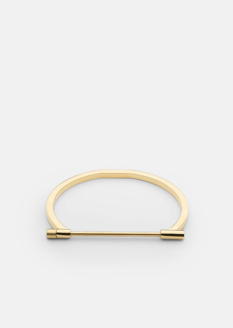 Gold plated Omega bangle by Skultuna, featuring a sleek and minimalist design in shiny gold finish.