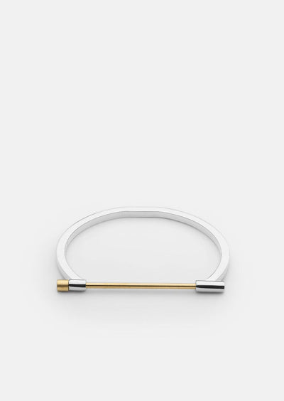 Gold plated Omega bangle by Skultuna with polished steel finish, showcasing a sleek, modern accessory design.