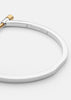 Gold plated Omega bangle by Skultuna with polished steel finish, showcasing a sleek, modern accessory design.