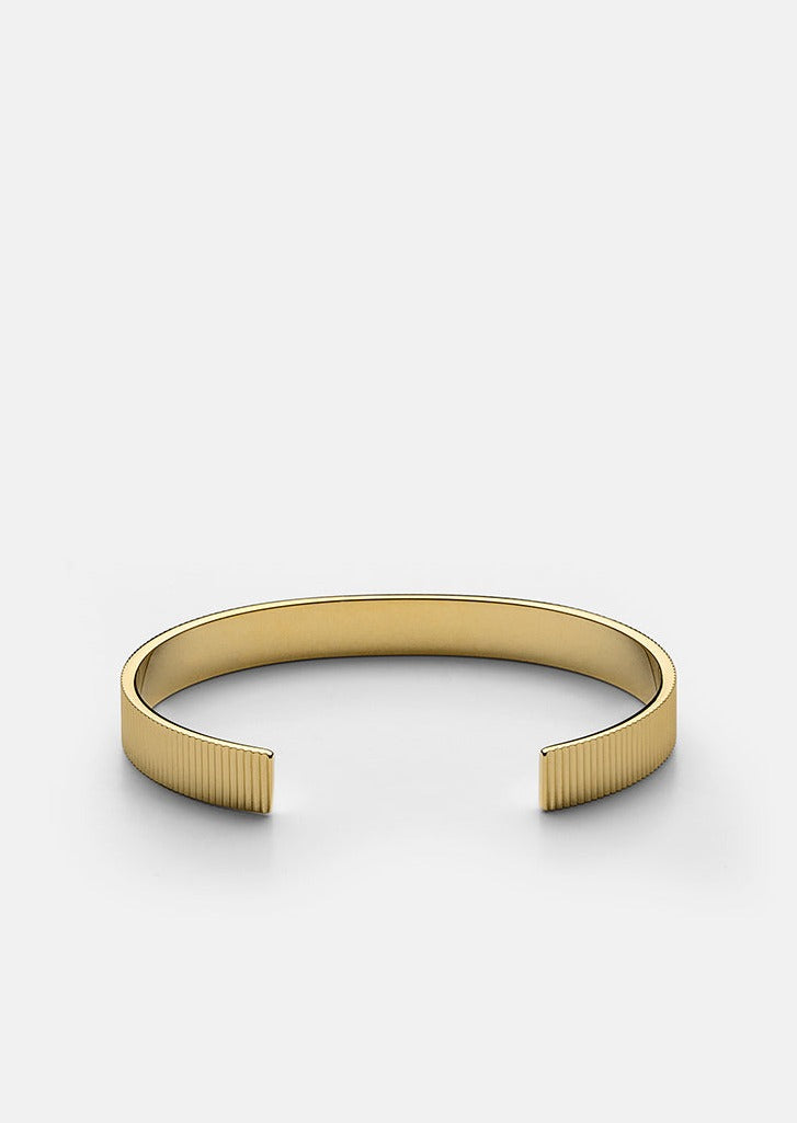Gold plated ribbed cuff bracelet by Skultuna, featuring textured design and adjustable fit, stylish accessories for everyday wear.