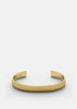Gold plated ribbed cuff bracelet by Skultuna, featuring textured design and polished finish, displayed on a neutral background.